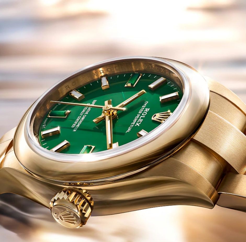 Rolex Oyster Perpetual 28 with a green lacquer dial and yellow gold case.