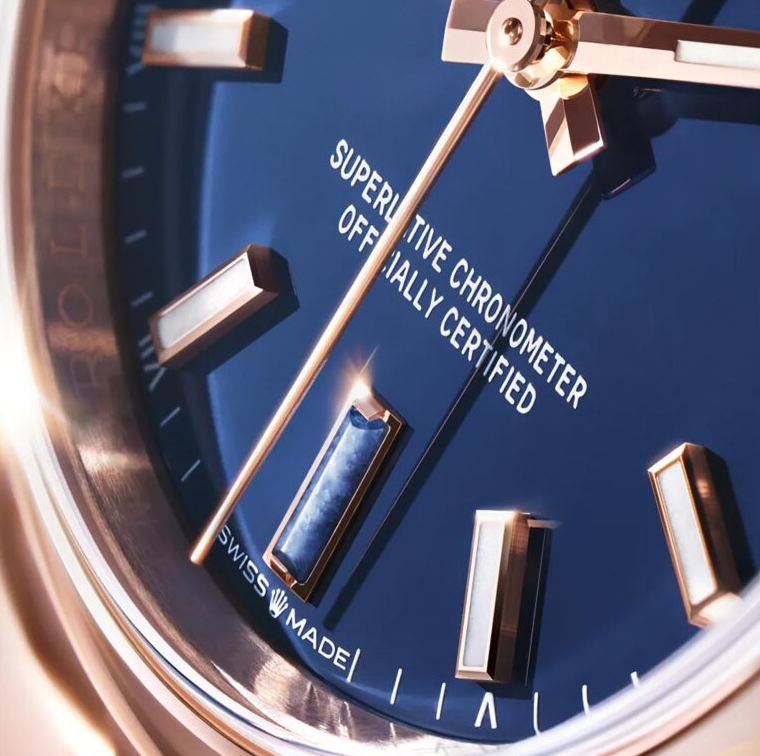 Close up of the blue Oyster Perpetual dial showing applied hour markers and dial lettering.